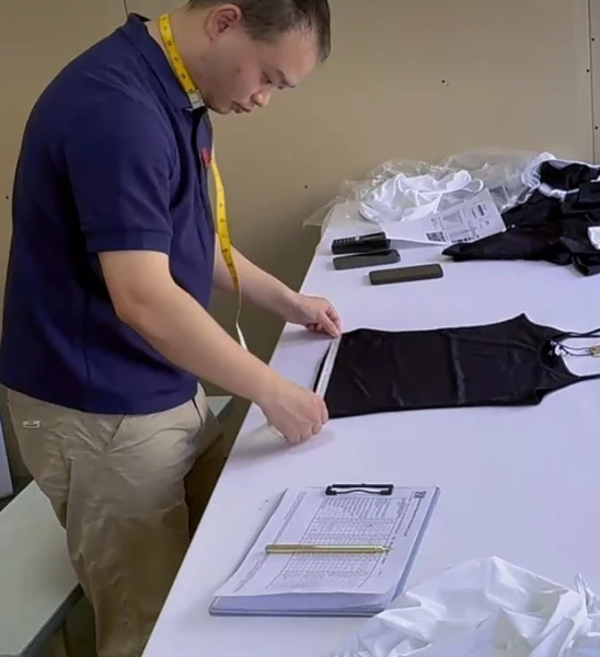 FlatFee Sourcing - Inspector running pre-shipment apparel quality control and AQL 2.5 statistical textile checking